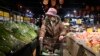 A woman selects vegetables at a supermarket in Beijing, on Jan. 9, 2025.