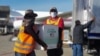 FILE - Workers unload 1.5 million doses of Moderna vaccine donated by the U.S. through the COVAX scheme, at the Armando Escalon aerial base, in San Pedro Sula, Honduras, June 27, 2021, in this handout picture released by the Honduran presidency.