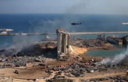 FILE - A general view shows the damaged grain silos of Beirut&#39;s harbor and its surroundings on Aug. 5, 2020, one day after a powerful twin explosion tore through Lebanon&#39;s capital.