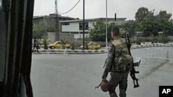 In this image taken on a mobile phone, a Syrian soldier patrols streets in Damascus, Syria, May 8, 2011