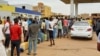 People gather to get fuel at a station, as clashes between the paramilitary Rapid Support Forces and the army continue, in south Khartoum locality, Sudan, April 30, 2023.