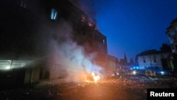 FILE - A residential building and cars burn following Russian missile and drone strikes in Lviv, Ukraine, Sept. 4, 2024.