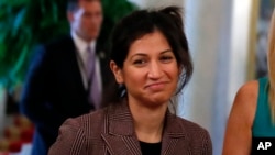 In this April 29, 2020, photo, Katie Miller, press secretary for Vice President Mike Pence, listens as President Donald Trump speaks about reopening the country, during a roundtable with industry executives in Washington. 