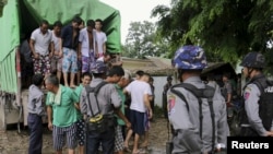 FILE - Chinese nationals, believed to be involved in illegal logging, arrive at a court in Myitkyina, capital of Kachin State in the north of Myanmar, July 22, 2015.