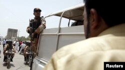 FILE - A soldier stands guard in Karachi, Pakistan, May 13, 2015. The military has been accused by opposition parties in Pakistan of kidnapping a senior police official to force him to arrest an opposition leader.