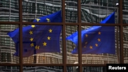 A European flag reflects in a building of the EU headquarters in Brussels. (File)