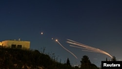 Israel's Iron Dome antimissile system intercepts rockets launched by Hezbollah from Lebanon toward Israel, as seen from northern Israel on April 12, 2024.