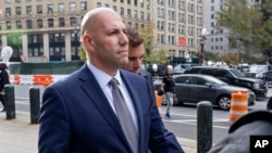 David Correia, center, leaves federal court Oct. 17, 2019, in New York. Correia and Andrey Kukushkin pleaded not guilty of conspiring with associates of Rudy Giuliani to make illegal campaign contributions. 