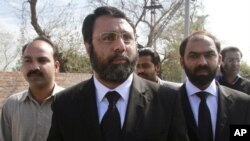 Asad Manzoor Butt (C) and Numan Attique (R), lawyers for the families of the two men killed by U.S. contractor Raymond Davis, walk together with the victim's brother, Imran Haider (L), after attending Davis' hearing in Lahore, March 8, 2011