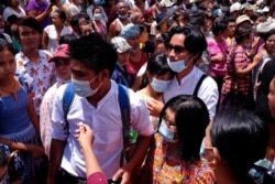 Zay Yar Lwin, center left, and Paing Pyo Min, center right in white, members of a theatrical troupe sentenced to prison in 2019 for gibes about the military, are pictured after their release from Insein Prison in Yangon, Myanmar, April 17, 2021.