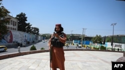 A Taliban fighter stands guard at the Massoud Square in Kabul on Aug. 16, 2021.