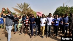 FILE - Sudanese demonstrators chant slogans as they participate in anti-government protests in Khartoum, Sudan, Jan. 17, 2019. 
