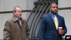 William Porter, right, one of six Baltimore city police officers charged in connection to the death of Freddie Gray, walks into a courthouse with his attorney Joseph Murtha for jury selection in his trial, Nov. 30, 2015, in Baltimore.