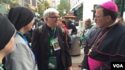 Clergy and nuns gather outside the World Meeting of Families the day before Pope Francis is due to visit the City of Brotherly Love, Philadelphia, Pennsylvania, Sept. 25, 2015. (J. Socolovsky/VOA)