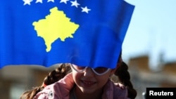 A child attends a parade during celebrations of the 15th anniversary of Kosovo independence in Pristina, Kosovo, Feb. 17, 2023.