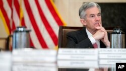 FILE - Gov. Jerome Powell attends a Board of Governors meeting at the Marriner S. Eccles Federal Reserve Board Building in Washington, Nov. 30, 2015. 