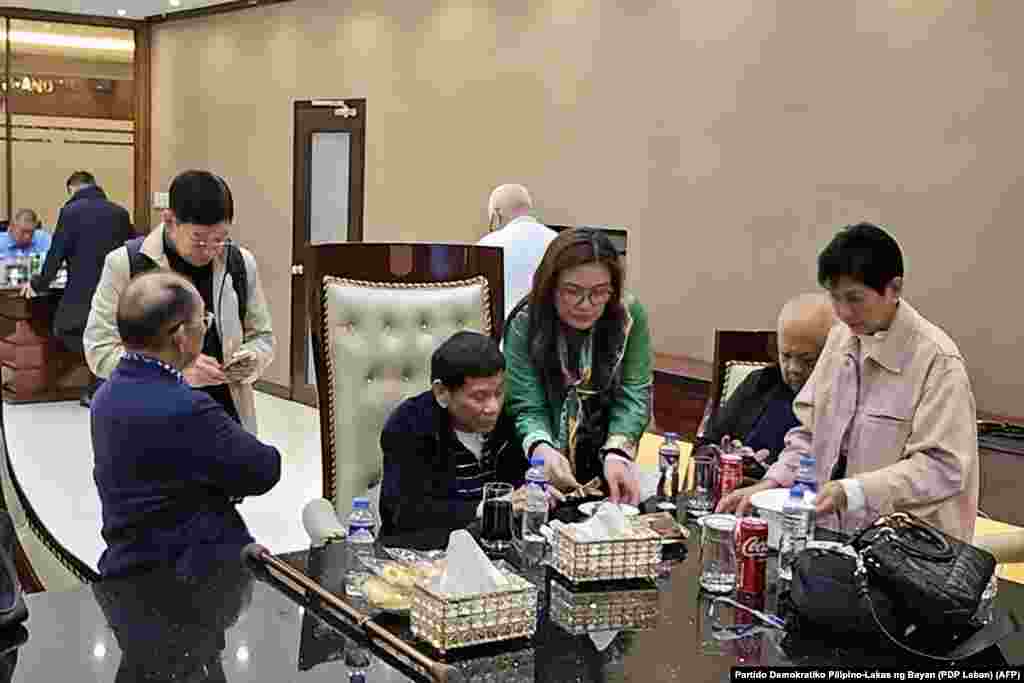 Former Philippines' president Rodrigo Duterte (C) is seen inside the Villamor Air Base in Pasay, Metro Manila, after arriving from Hong Kong. Duterte was arrested on an International Criminal Court warrant for alleged crimes against humanity during his "war on drugs," once said he would be happy to kill three million addicts. 