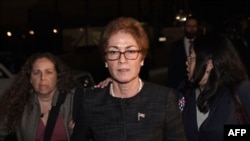 Former U.S. Ambassador to Ukraine Marie Yovanovitch, center, flanked by lawyers, aides and Capitol police, leaves the Capitol, Oct. 11, 2019, in Washington, after testifying to the House Intelligence, Foreign Affairs and Oversight committees.