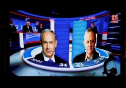The results of exit polls are shown on a screen at Benny Gantz's Blue and White party headquarters, following Israel's parliamentary election, in Tel Aviv, Israel, Sept. 17, 2019.
