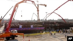 In this photo by the Atomic Energy Organization of Iran, concrete is poured for the base of the second nuclear power reactor at Bushehr plant, some 440 miles (700 kilometers) south of Tehran, Nov. 10, 2019. 