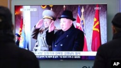 People watch a TV showing North Korean leader Kim Jong Un during a military parade in Pyongyang, North Korea, at Seoul Railway Station in Seoul, South Korea, Feb. 8, 2018.