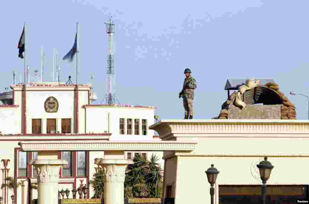 A soldier stands guard outside the Almaza military airbase where a military funeral of security personnel killed in attacks in Sinai is being held, in Cairo, Jan. 30, 2015.