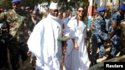 Gambian President Yahya Jammeh arrives at a polling station with his wife, Zineb, during the presidential election in Banjul, Gambia, Dec. 1, 2016.