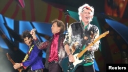 Keith Richards (R), Mick Jagger (C) and Ronnie Wood of the Rolling Stones perform a free outdoor concert at Ciudad Deportiva de la Habana sports complex in Havana, Cuba, March 25, 2016. REUTERS/Alexandre Meneghini