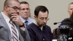 Larry Nassar sits with attorney Matt Newburg during his sentencing hearing, Jan. 24, 2018, in Lansing, Mich. 