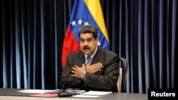 Venezuela's President Nicolas Maduro gestures as he talks to the media during a news conference at Miraflores Palace in Caracas, Venezuela, Sept. 18, 2018.