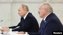 FILE - Russian President Vladimir Putin and Belarusian President Alexander Lukashenko attend a meeting at the Kremlin in Moscow, Russia April 6, 2023. Sputnik/Mikhail Klimentyev/Kremlin via REUTERS