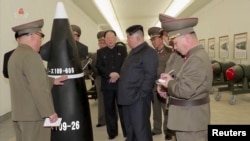A screen grab shows North Korean leader Kim Jong Un inspecting nuclear warheads at an undisclosed location in this undated still image used in a video. KRT/via Reuters TV/Handout via REUTERS