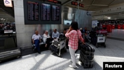 Passengers wait for their flights at Turkey's largest airport, Istanbul Ataturk, following yesterday's blast, June 29, 2016. 