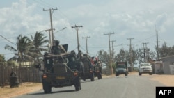 A military convoy of South Africa National Defense Forces patrols in Pemba, Aug. 5, 2021. The Southern African Development Community bloc is rallying behind neighboring Mozambique, sending troops to battle jihadists wreaking havoc in the north.