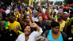 Members of the African National Congress (ANC) and mourners sing to celebrate the life of Nelson Mandela outside his old house in Soweto, Johannesburg, South Africa, Dec. 8. 2013.