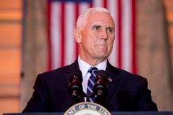 FILE - Vice President Mike Pence pauses while speaking to troops at Al Asad Air Base, Iraq, Nov. 23, 2019.