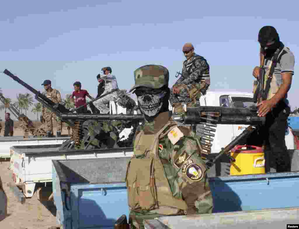 A Shi'ite volunteer who joined the Iraqi army to fight against predominantly Sunni militants from the radical Islamic State of Iraq and the Levant looks on during a parade in Kanaan, Iraq, June 26, 2014.