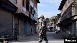 ndian security forces personnel stand guard in front of closed shops during restrictions imposed by authorities following the death of Syed Ali Shah Geelani, a Kashmiri veteran separatist politician, in Srinagar Sept. 3, 2021.