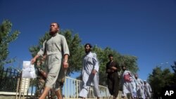 FILE - Afghan Taliban prisoners are released from Bagram Prison in Parwan province, Afghanistan, May 26, 2020.