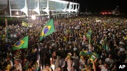 Demonstrators call for the impeachment of Brazil's President Dilma Rousseff and protest the naming of her mentor, former President Luiz Inacio Lula da Silva, as her new chief of staff, outside Planalto presidential palace in Brasilia, Brazil, Wednesday, M