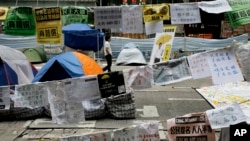 A pro-democracy protester walks at a main road in the occupied area of the Causeway Bay district in Hong Kong, Nov. 5, 2014. 