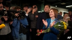 Moldova's President Maia Sandu celebrates with supporters as preliminary results are announced for the presidential election runoff in Chisinau, Moldova, Nov. 3, 2024.