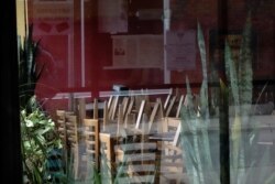 Stacked chairs are seen inside the closed Lao Laan Xang Restaurant as the coronavirus disease (COVID-19) outbreak continues in Madison, Oct. 20, 2020.