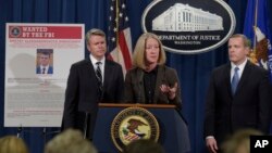 Acting Assistant Attorney General Mary McCord, center, announced charges against four defendants, including two officers of Russian security services, for a mega data breach at Yahoo. (AP Photo/Susan Walsh)