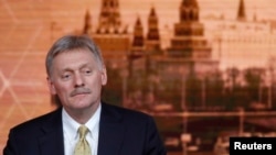 FILE - Kremlin spokesman Dmitry Peskov listens during Russian President Vladimir Putin's annual end-of-year news conference in Moscow, Russia, Dec. 19, 2019. 