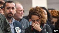 Lawyers and opposition MPs gather outside the Caglayan courthouse, Feb. 21, 2019, in Istanbul, to protest against the upholding by an appeals court of jail sentences against journalists in a long-running case targeting the Cumhuriyet newspaper.
