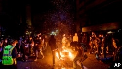Demonstrators burn garbage in Oakland, Calif., on May 29, 2020, while protesting the Monday death of George Floyd, a handcuffed black man in police custody in Minneapolis. 