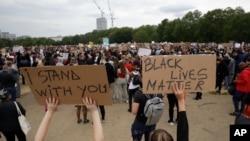 Protesters take part in a demonstration on Wednesday, June 3, 2020, in Hyde Park, London, over the death of George Floyd, a black man who died after being restrained by Minneapolis police officers on May 25. 