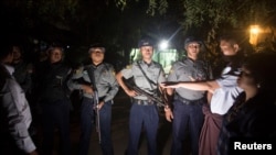 Myanmar Police stand guard at the forensic department of a hospital where the body of Ko Ni is kept, a prominent member of Myanmar's Muslim minority and legal adviser for Myanmar's ruling National League for Democracy, in Yangon, Jan. 29, 2017. 