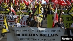 People take part in a protest against the U.S. pressure for Poland to compensate Jewish families for property they lost during the Holocaust, in Warsaw, Poland, May 11, 2019. 